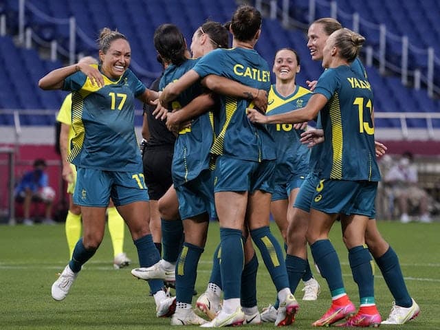 Team Australia embrace Australia player Sam Kerr (2) after she scored her second goal of the game to go ahead 2-1 during the Tokyo 2020 Olympic Summer Games at Saitama Stadium on July 24, 2021