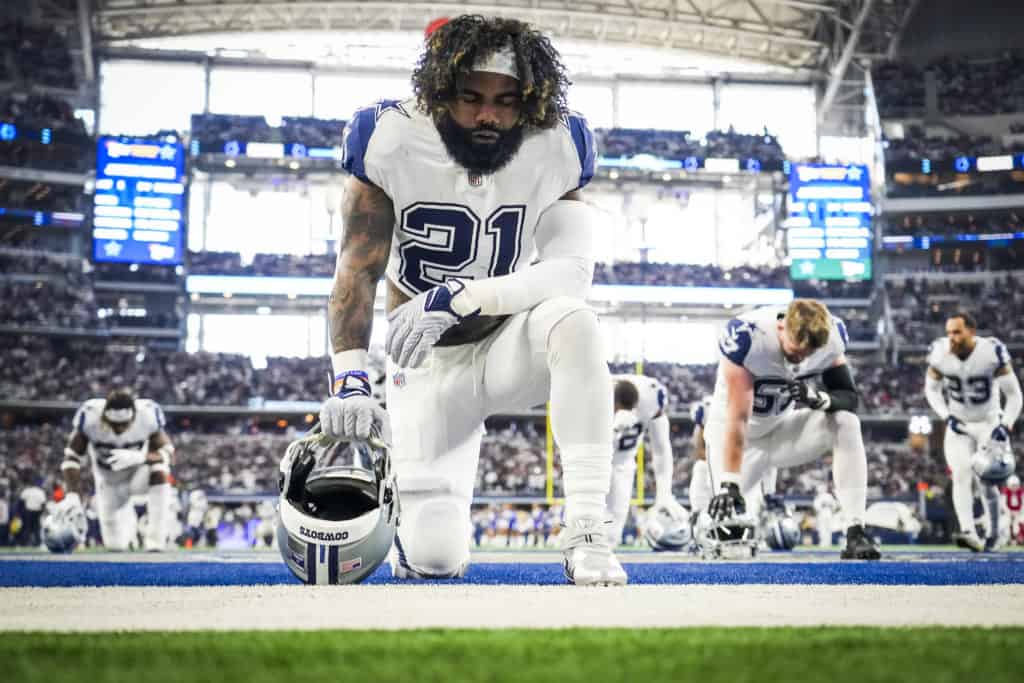 A Dallas Cowboyts Player kneeling beofre a football game
