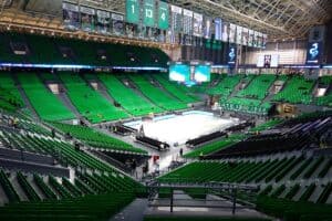 Telekom Center Athens Greece - Gambyl Sports Betting Exchange Empty indoor sports arena with green seats and large digital screens displaying event details.